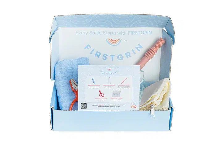 Blue and white Firstaids first aid kit box with medical supplies and instruction materials visible.