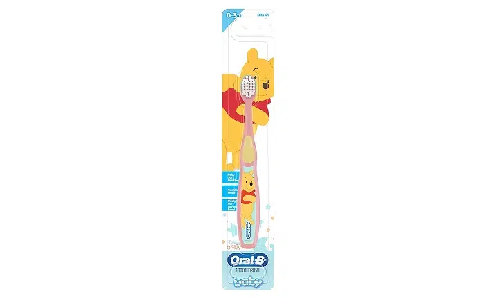 Oral-B children's toothbrush featuring Winnie the Pooh character design in yellow packaging.