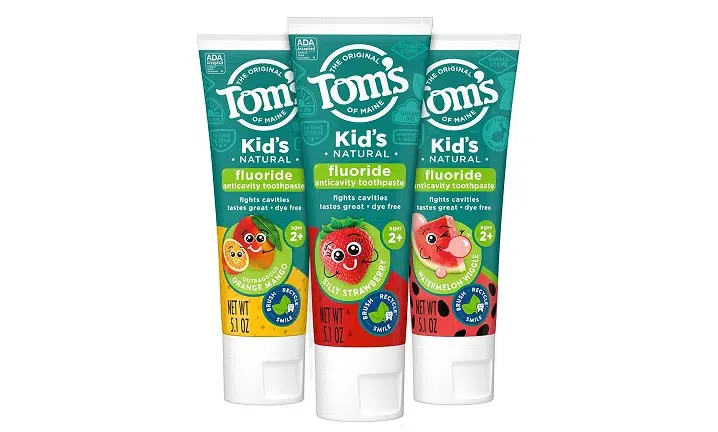 Three Tom's Kids toothpaste tubes in fruity flavors displayed against white background.