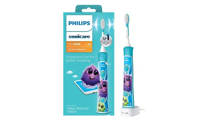 Philips Sonicare Kids electric toothbrush with purple whale design and blue handle in packaging.