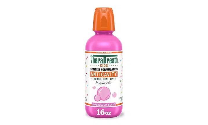 Therabreath antiseptic oral rinse bottle with pink liquid and orange cap on white background.