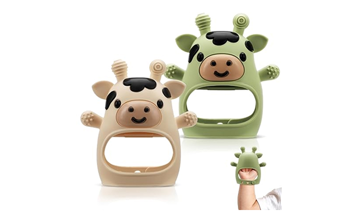 Two plush cow teething toys in tan and green with horns and smiling faces.
